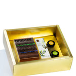 Gold gift box with 'Coffeeverse' and 'Blossom' products on a white background