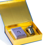 Open gold box containing a purple book titled 'Coffee Verse' and a silver cup on a white background