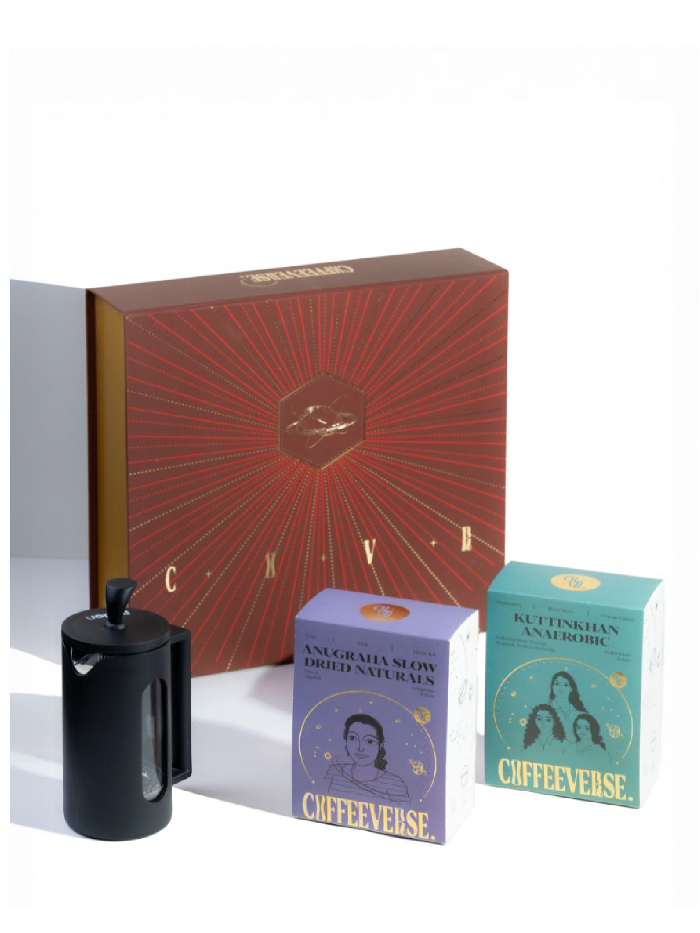 Coffee-themed gift set with a red box, french press, and two small boxes labeled 'Coffeeverse' on a white background.