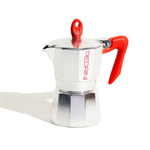 Silver espresso maker with red handles on a white background