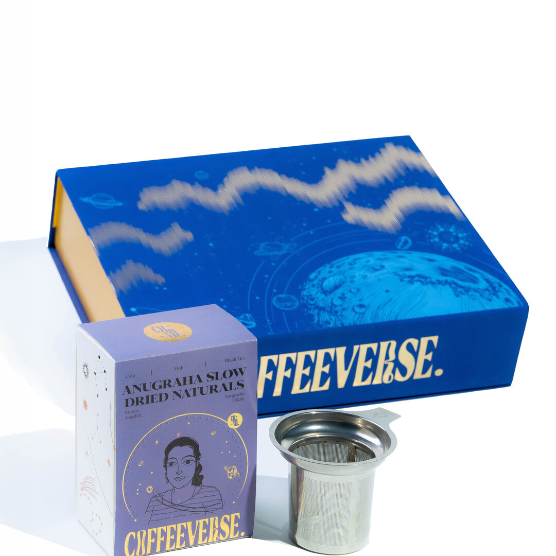 Coffeeverse product set including a blue box, purple packaging, and metal filter on a white background