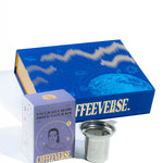 Coffeeverse product set including a blue box, purple packaging, and metal filter on a white background