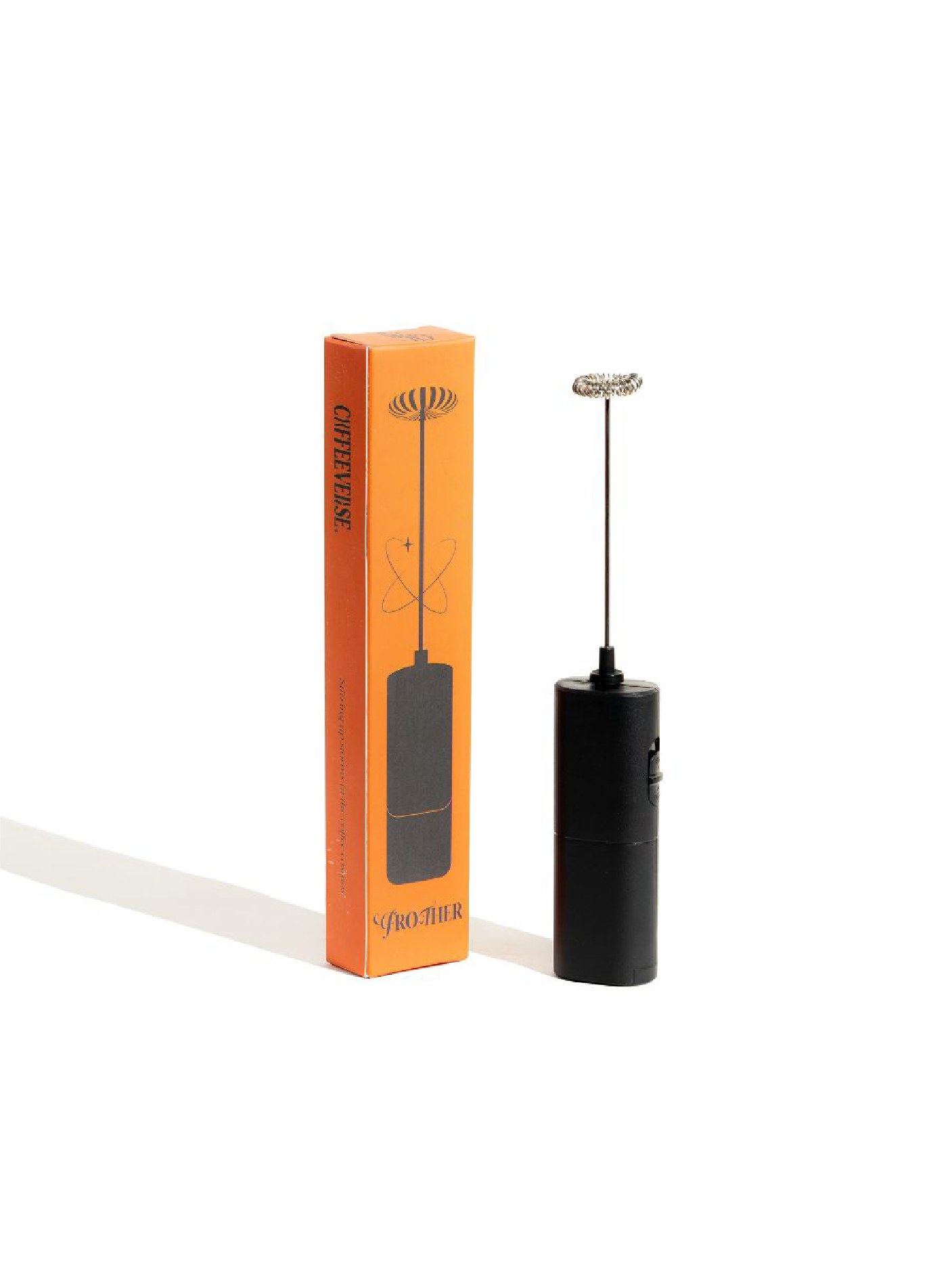 Black milk frother with orange packaging on a white background