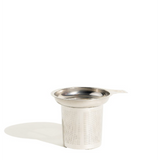 Metallic tea infuser on a white background