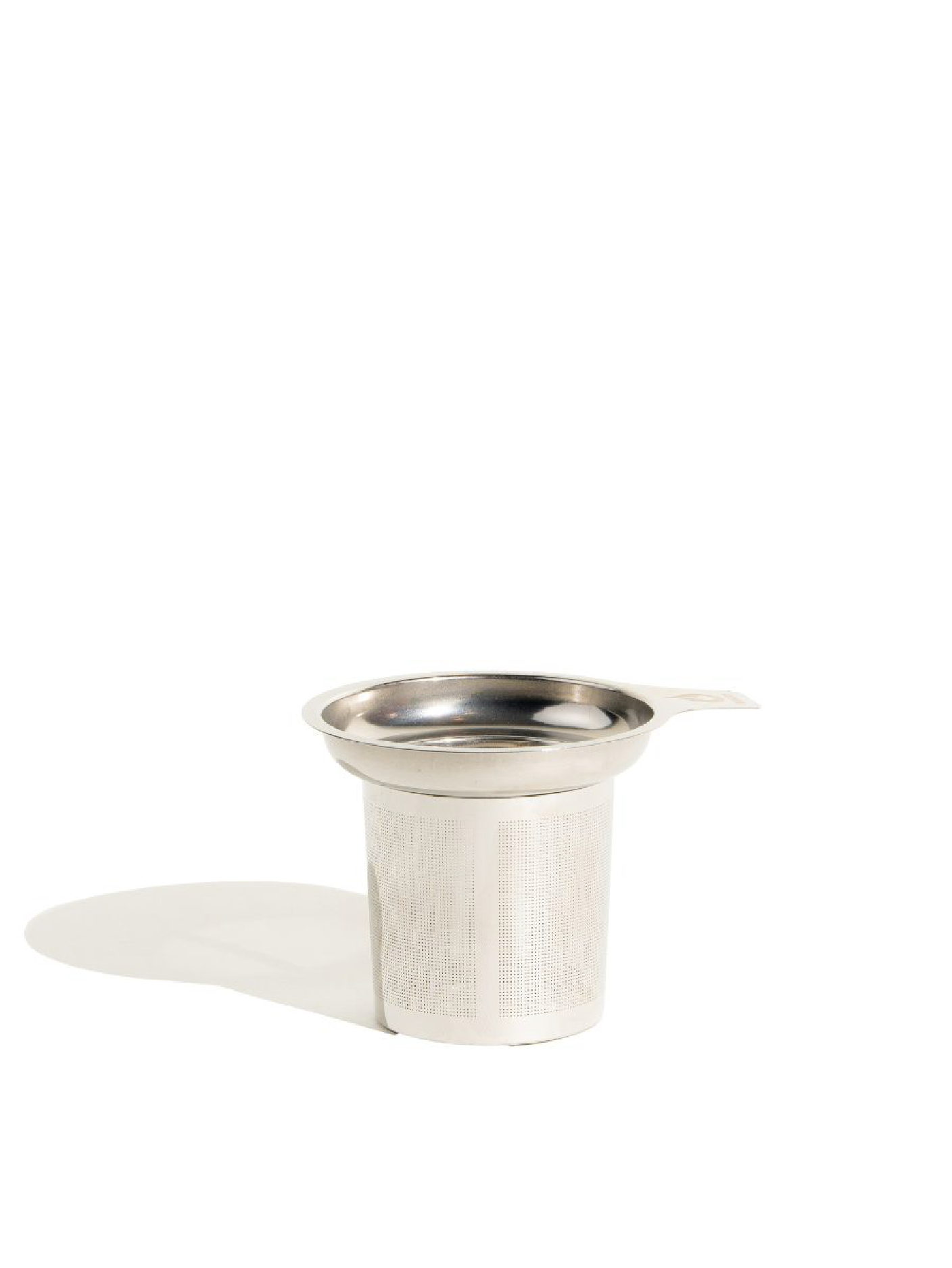 Metallic tea infuser on a white background